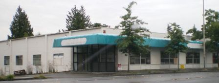 By 2007 the old grocery building at 8606 35th Ave NE was at the end of its useful life. It stood vacant while a redevelopment project was on hold.