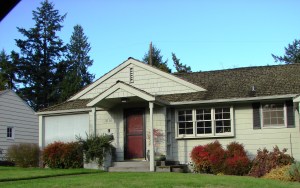 This 1942 Balch-built house in Wedgwood has a porch portico with a gable and columns, emphasizing the entry in Colonial style.
