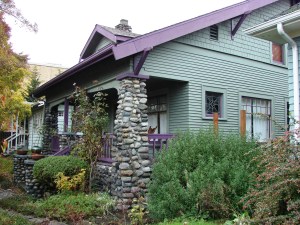 This Craftsman house built in 1911 shows the influence of the Arts and Crafts movement in its river rock front porch posts. The fireplace and chimney are of the same composition. The Craftsman movement included emphasis on fine woodwork and other "crafts" to make houses beautiful.