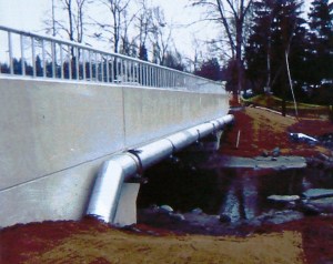 A creek runs under it: a section of 35th Ave NE has been rebuilt with a bridge structure so that the South Branch of Thornton Creek is daylighted.