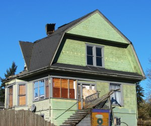 Demolition shovel chews at the back of the house