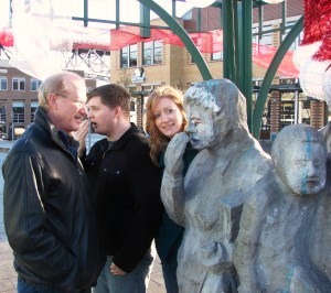 Valarie's husband, son-in-law and daughter with the Waiting for the Interurban statue in Fremont.