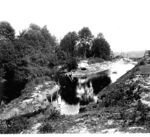 This 1906 photo shows how the creek had been enlarged into a canal large enough to send logs floating to mill, before the creation of the present-day ship canal.