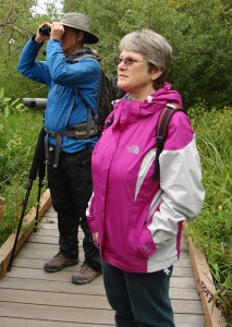 Walk leader Joe Sweeney spots a bird while Valarie's friend Debbie is taking in the beauty of Union Bay.