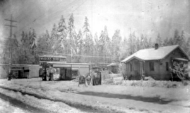 This photo circa 1927 shows the Shauers house (present site of Wells Fargo Bank) with the new gas station Mr. Shauer had opened.