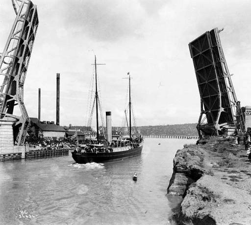 At the ship canal opening day celebration on July 4, 1917, we see the new Fremont Bridge. Beyond it to the east is the Stone Way trestle bridge. Photo courtesy of University of Washington Special Collections.